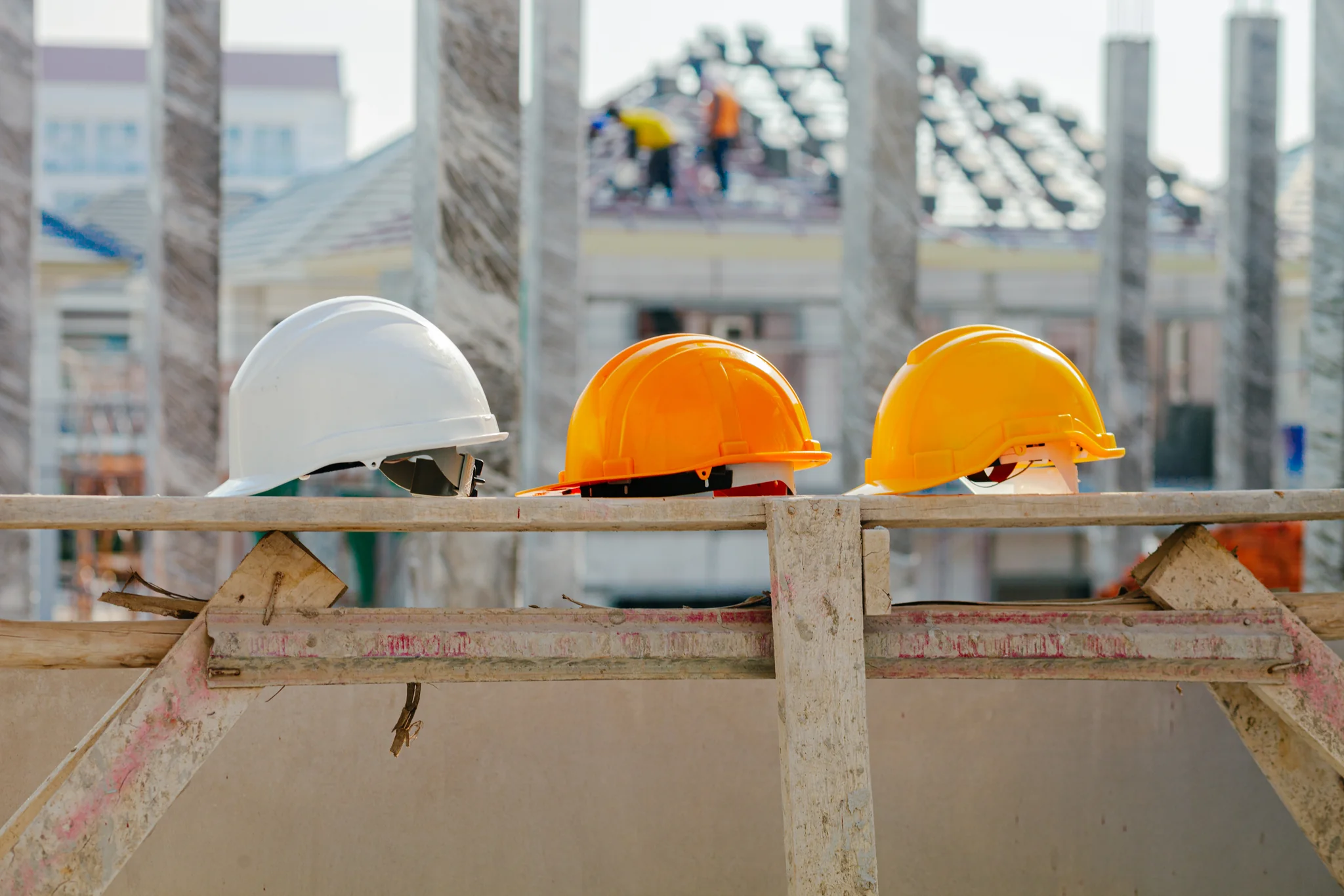Green hard hats placed on a wooden structure